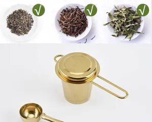 Gold stainless steel tea infuser detail showing mesh basket, lid, handle, and matching scoop.