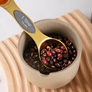 Stainless steel gold measuring spoon with clear scale markings for kitchen baking cooking use.