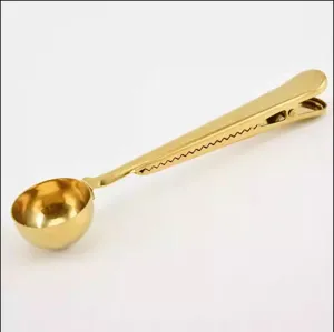Gold stainless steel coffee scoop with bag clip, multi-functional kitchen tool main view.