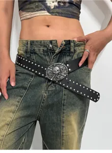 Detail shot of punk style black leather belt with metal studs and snake skull buckle.