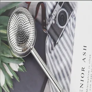 Stainless steel telescopic tea infuser ball with push handle for loose leaf tea brewing filter.