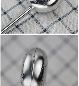 Detailed close-up shot of stainless steel tea infuser featuring a perforated mesh ball and handle.