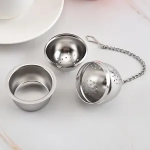 Stainless steel tea infuser ball with chain and drip tray for loose leaf tea brewing.