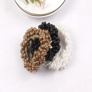 Lot de trois élastiques à cheveux en perles élégants en bronze, noir et blanc.