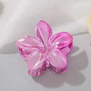 Macro view of a metallic pink plumeria hair claw clip with high-gloss mirror finish