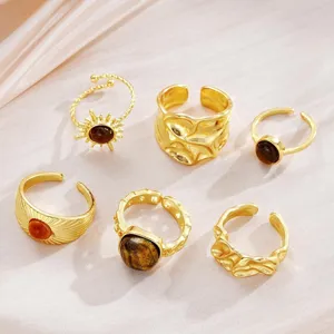 Detailed view of vintage gold ring set with tiger eye stones and sunflower design