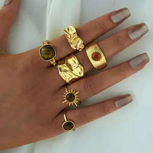 Vintage gold plated ring set featuring tiger eye stones and textured sunburst designs