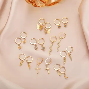 High-quality detail of 9 pairs gold hoop earring set with butterfly and cross charms