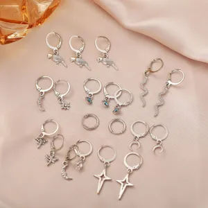 Macro shot of a 9-pair silver earring set featuring snake, moon, star and eye charms