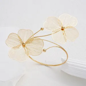 Macro view showing the intricate gold hollow floral design on this elegant anklet.
