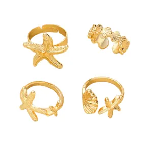 Modisches 4-teiliges Ring-Set in Gold mit Meeresmotiven wie Seesternen und Muscheln