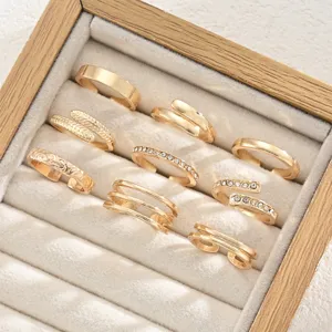 Detailed view of nine-piece golden toe ring set in a velvet jewelry box