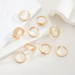 Elegant set of 9 golden open toe rings featuring rhinestones and minimalist engraved designs