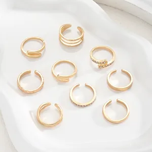 Set of 9 gold adjustable toe rings featuring rhinestone accents and textured bands