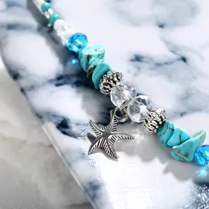 Close-up detail of bohemian beach anklet with starfish charm, turquoise and crystal beads