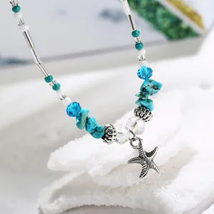 Detailed close-up of a bohemian starfish anklet featuring turquoise beads and crystals