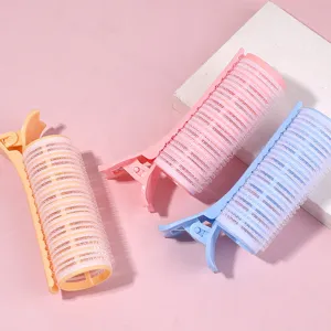 Detail view of three colorful French hair roller clips for root volume and bangs
