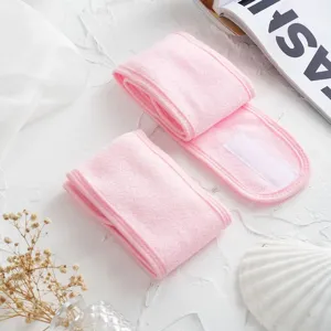 Close-up of soft pink spa headbands with adjustable velcro closure details