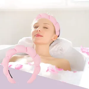 Soft pink sponge twisted headband for face washing and professional spa skin care routine