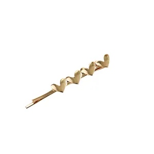 Elegant gold metal hair clip featuring five overlapping hearts in a Korean bobby pin style