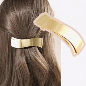 Elegante molletta per capelli in metallo dorato dal design geometrico curvo minimalista.