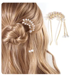 Detail view of elegant gold hair fork with pearls and crystals in blonde hair