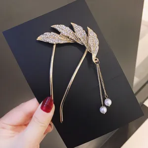 Elegant gold-tone hair fork with sparkling rhinestones and dangling pearls for Hanfu styling.