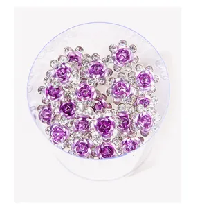 Top view of purple rose rhinestone hair pins in a clear cylindrical container
