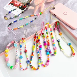 Detailed view of colorful ethnic style beaded phone charms with heart and flower motifs