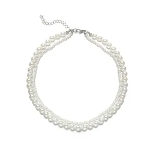 Vue macro détaillée d'un élégant collier de fausses perles à deux rangs avec fermoir argenté