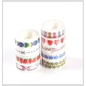 Detailed shot of decorative washi tape rolls with cute hand-drawn patterns and cute designs.