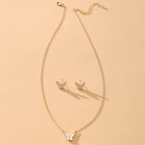 Detail view of an elegant gold butterfly necklace and stud earrings jewelry set.
