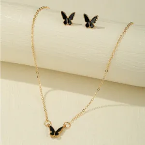 Elegant detail shot of a vintage butterfly jewelry set including necklace and earrings.