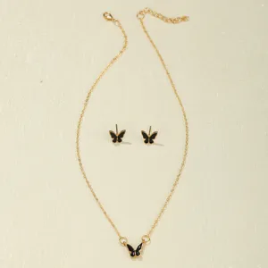 Detailed view of black butterfly necklace and stud earrings set with gold chain