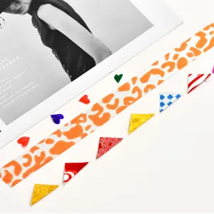 Glitter washi tape featuring vibrant orange leopard print and colorful decorative confetti pieces.