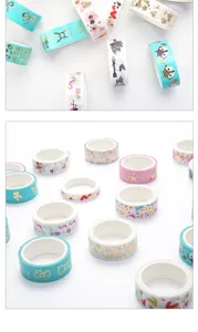 Detailed close-up shot of colorful decorative gold foil washi tape rolls with various patterns.