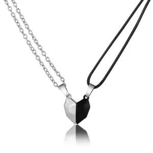 Detail view of magnetic split heart pendants for couples in silver and black finish