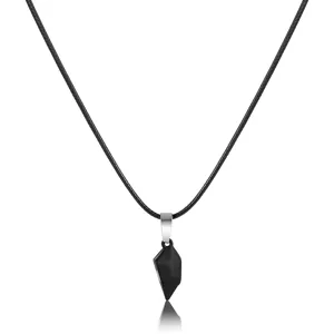 Close-up of a black magnetic half-heart pendant on a black cord necklace for couples