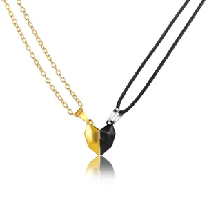 Pair of magnetic heart pendant necklaces for couples in contrasting black and gold colors