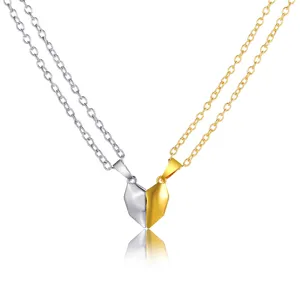 Close-up of magnetic split heart pendant necklaces for couples in gold and silver finish
