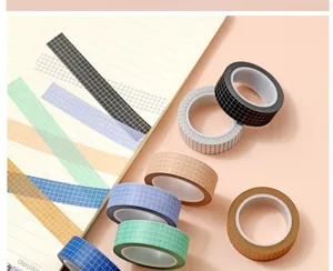 Detail view of colorful grid washi tape rolls and sample strips for journal decoration.