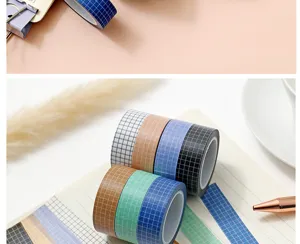 Close-up detail of colorful grid washi tape rolls and decorative strips for journaling.