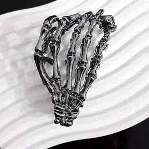 Unique skeleton hand metal hair claw clip with dark metallic finish for Halloween.