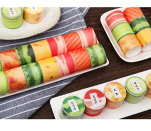Cute food design washi tape rolls featuring sushi and vegetable patterns for DIY craft journaling.