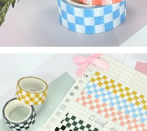 Close-up detail shot of colorful checkered washi tapes displayed on a journaling notebook.
