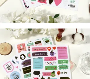 Close-up of gold foil planner stickers detail, decorative stationery supplies for creative journals.