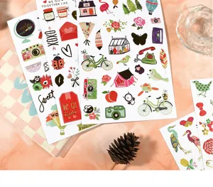 Close-up of cute gold foil flat stickers, perfect for DIY journaling and creative paper decoration.
