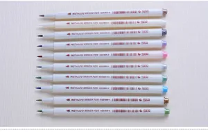 Detailed view of metallic brush pens set showing soft brush tips and neat parallel arrangement.