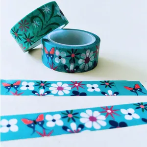 Decorative washi tape rolls featuring floral and butterfly patterns for journal DIY and crafts.