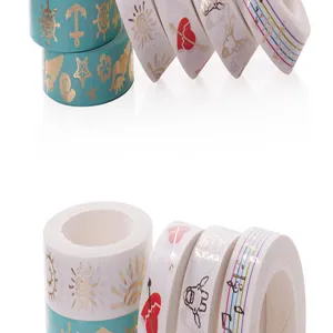 Detail closeup view of gold foiled decorative washi tape rolls, featuring cute patterns.